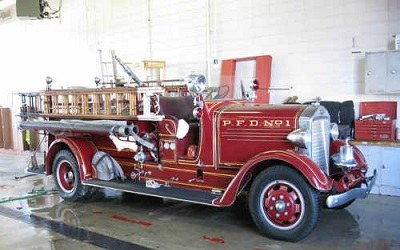 Restored antique red fire engine lettered P.F.D. No. 1.