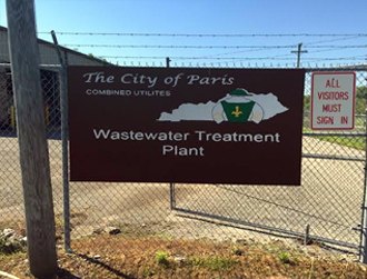 City of Paris Combined Utilities Wastewater Treatment Plant sign on a chain-link fence.